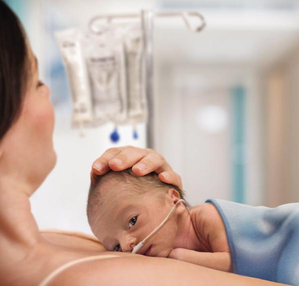 Premature baby in mother's arms Premature baby in mother's arms